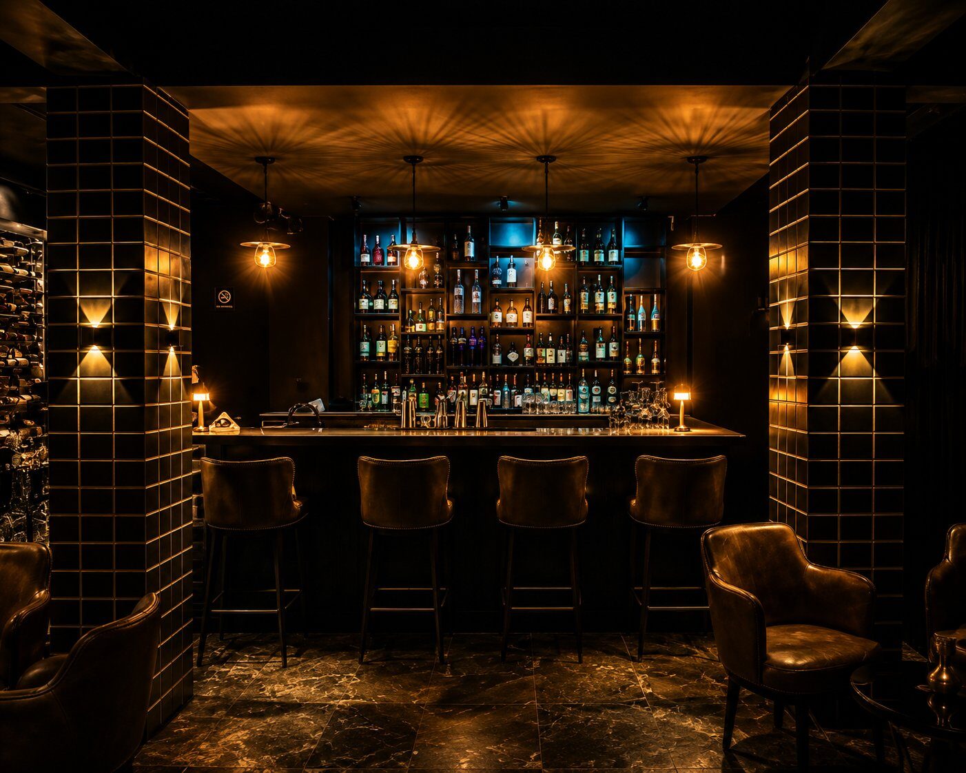 The bar at Kigali Lounge — backlit spirits, Edison pendant lights, leather stools
