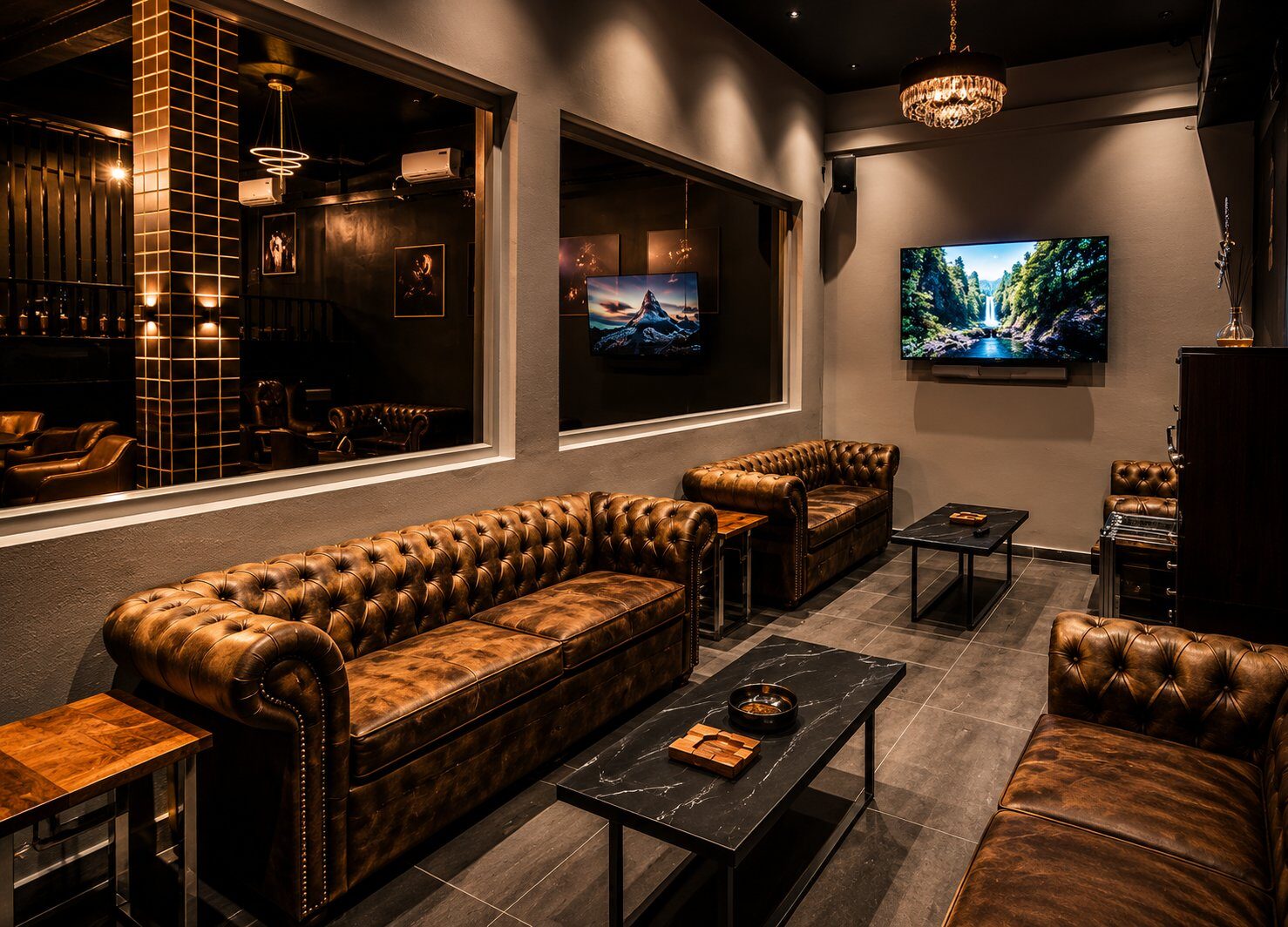 Chesterfield seating at Kigali Lounge — warm leather, low light, marble side tables