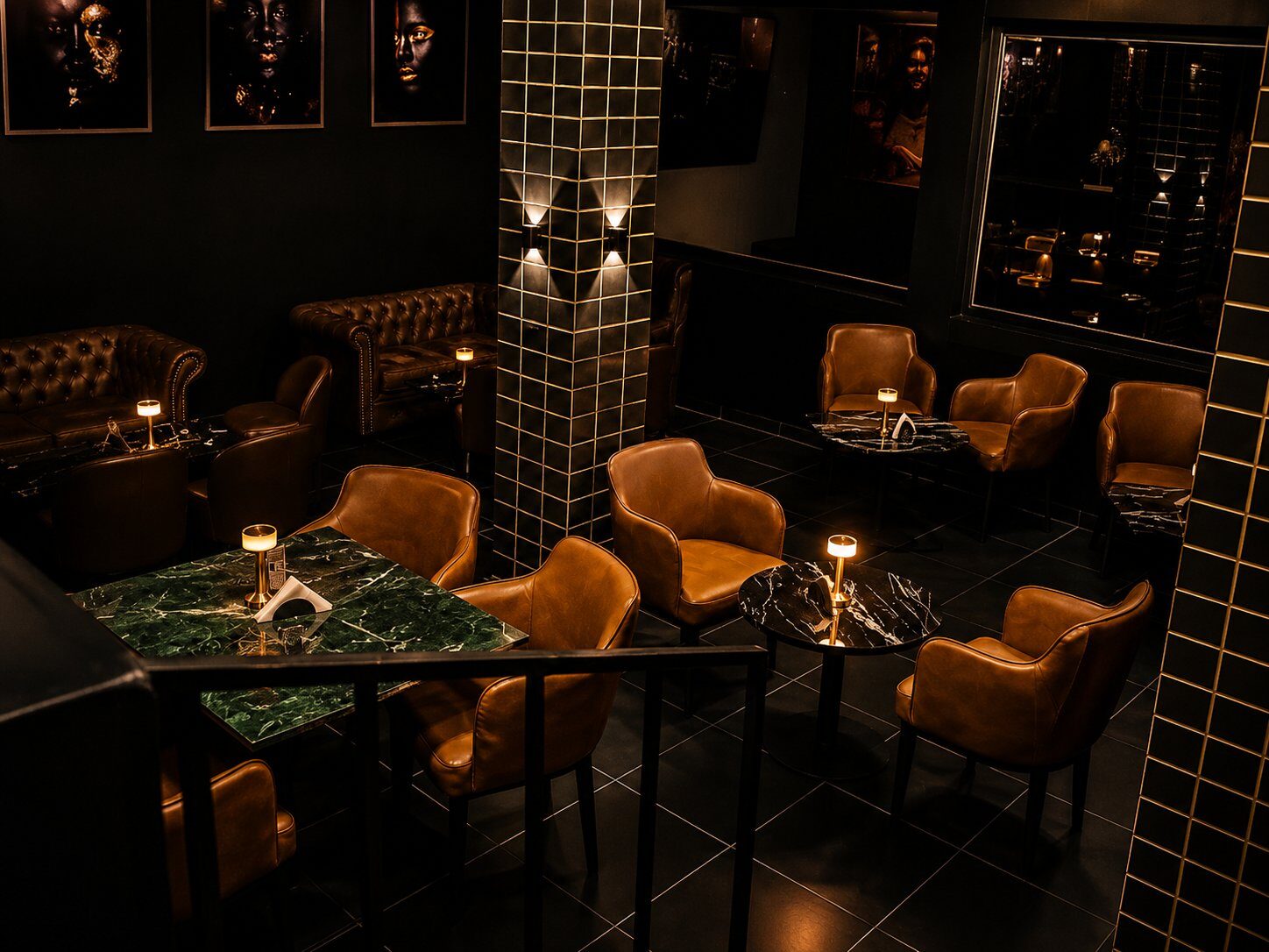 Main floor of Kigali Lounge — tan leather chairs, green marble tables, gold-grouted columns